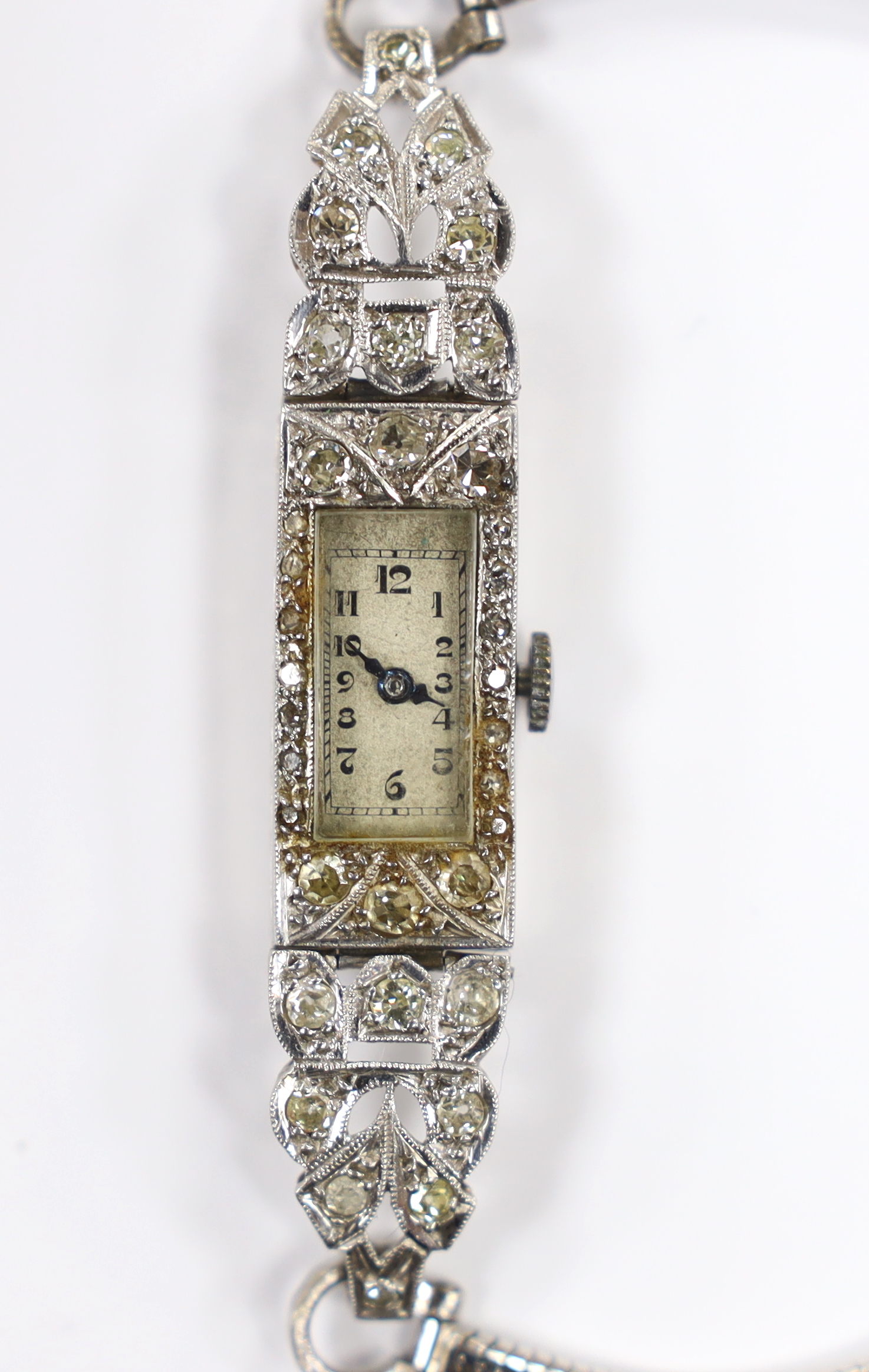 A lady's white metal stamped (All Platinum) and diamond cluster set manual wind cocktail watch, on a 9ct white gold bracelet, gross weight 14.3 grams.